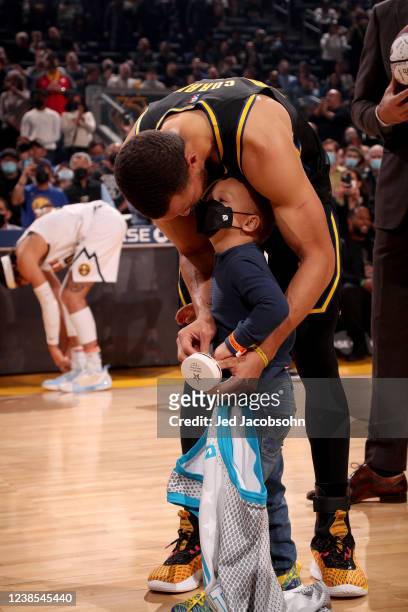 Stephen Curry of the Golden State Warriors and his son, Canon, during the All Star jersey presentation before the game against the Denver Nuggets on...