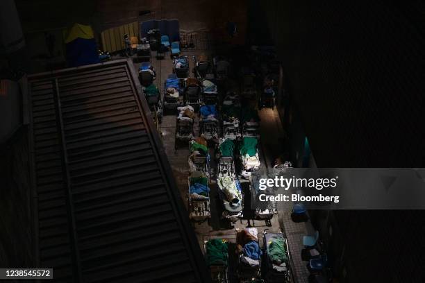 Patients displaying Covid-19 symptoms at a temporary triage area next to the emergency department at the Caritas Medical Center hospital at night in...