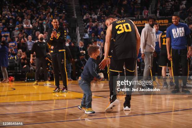 Stephen Curry of the Golden State Warriors and his son, Canon, before the game against the Denver Nuggets on February 16, 2022 at Chase Center in San...