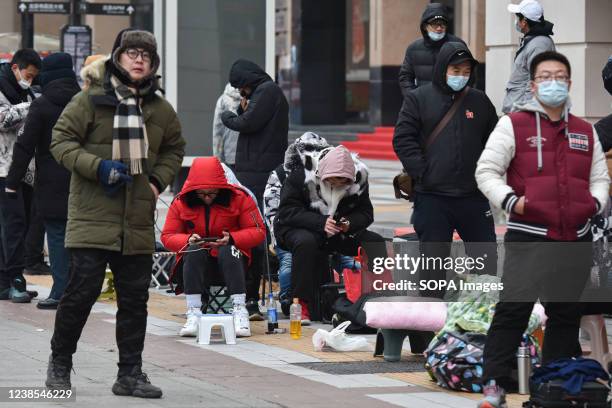 Customers are waiting in line to buy "Bing Dwen Dwen." Every day since the opening of the Beijing Winter Olympics, people have lined up outside the...