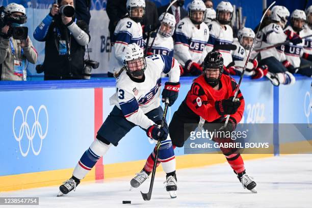 S Grace Zumwinkle passes the puck during the women's gold medal match of the Beijing 2022 Winter Olympic Games ice hockey competition between Canada...