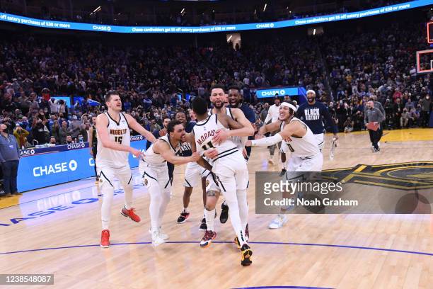 The Denver Nuggets celebrate Monte Morris of the Denver Nuggets scoring the game winning basket during the game against the Golden State Warriors on...