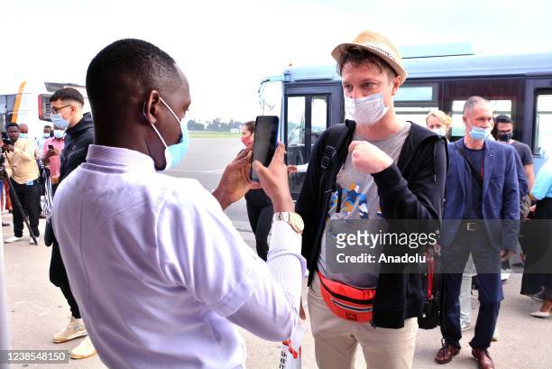 Airport staff scans tourists with EDE device after they arrive at Abeid Amani Karume International Airport in Zanzibar Island, Tanzania on February...