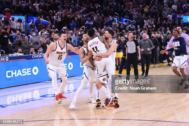 The Denver Nuggets celebrate Monte Morris of the Denver Nuggets scoring the game winning basket during the game against the Golden State Warriors on...