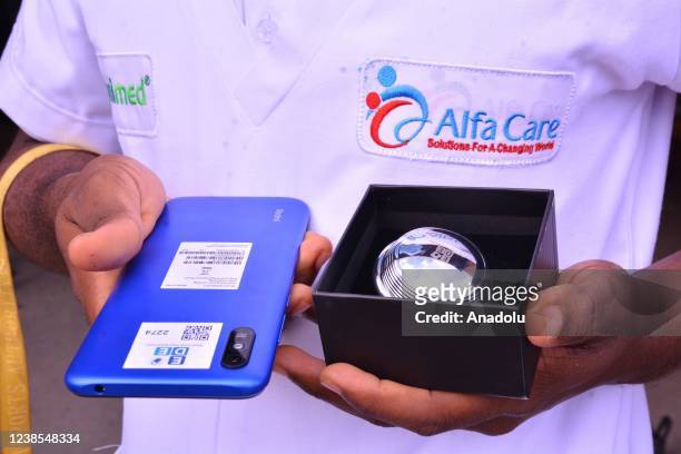 Airport staff holds a EDE device to scan toruits to detect possible Covid-19 infection after they arrive at Abeid Amani Karume International Airport...