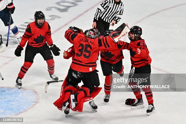 Canada's players celebrate their victory during the women's gold medal match of the Beijing 2022 Winter Olympic Games ice hockey competition between...
