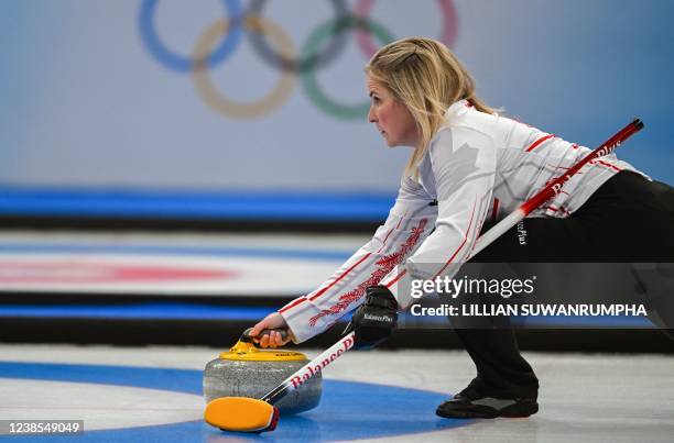 Canada's Jennifer Jones curls the stone during the women's round robin session 12 game of the Beijing 2022 Winter Olympic Games curling competition...