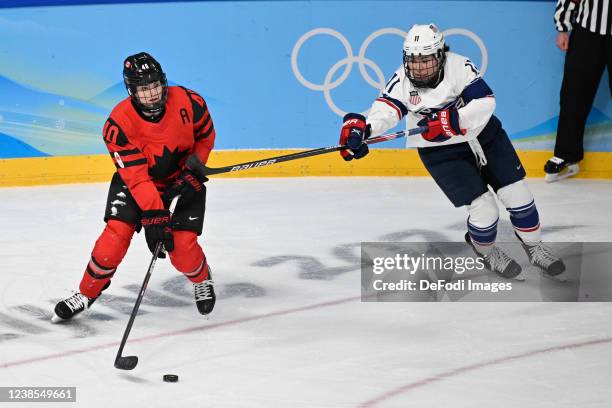 Blayre Turnbull of Canada and Abby Roque of USA battle for the puck at the women's ice hockey gold medal match between Canada and USA during the...