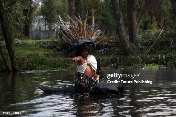 Man performs a ceremony in the canal as part of a campaign to preserve the endangered axolotl and its habitat. On February 16, 2022 In Mexico City,...