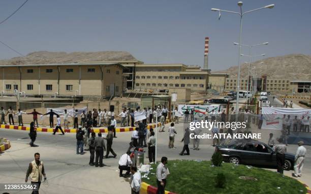 Iranian students are seen forming a human chain around a uranium conversion facility, demonstrating their support of Iran's decision to reopen the...