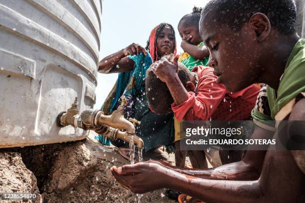 Internally displaced people wash themselves in a school in the village of Afdera, 225 kms of Semera, Ethiopia, on February 15, 2022. More than...