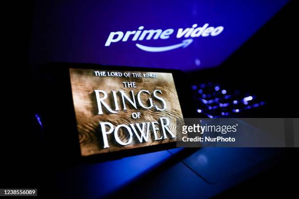 The Lord of the Rings: The Rings of Power series logo displayed on a phone screen and Prime Video logo displayed on a laptop screen are seen in this...