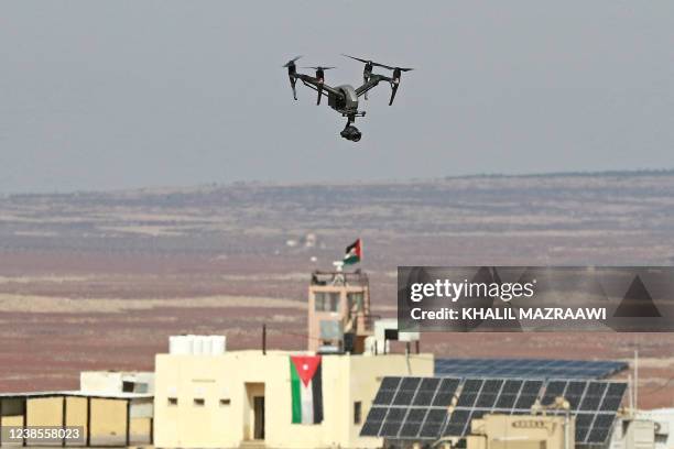 Picture taken during a tour origanized by the Jordanian Army shows a drone flying over an observation post along the border with Syria, on February...