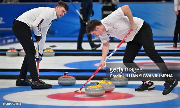 Britain's Bruce Mouat and Grant Hardie make their move during the men's semifinal game of the Beijing 2022 Winter Olympic Games curling competition...
