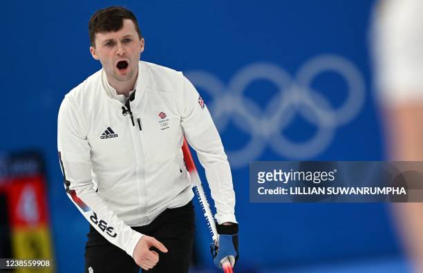 Britain's Bruce Mouat gives instructions during their men's semifinal game of the Beijing 2022 Winter Olympic Games curling competition against USA...