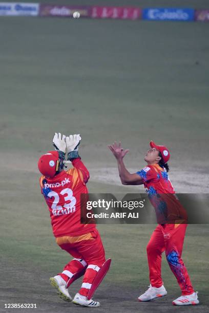 Islamabad United's Muhammad Musa and wicketkeeper Azam Khan attempt a catch of Peshawar Zalmi's Yasir Khan during the Pakistan Super League Twenty20...