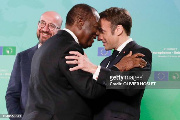 Ivory Coast's President Alassane Ouattara is welcomed by President of the European Council Charles Michel and France's President Emmanuel Macron...