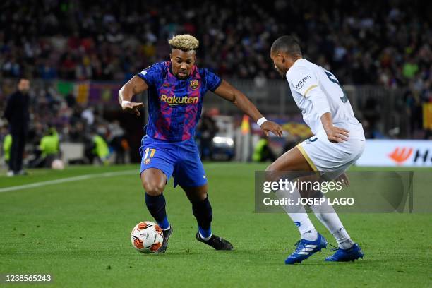 Barcelona's Spanish forward Adama Traore vies with Napoli's Brazil's defender Juan Jesus during the Europa League football match between FC Barcelona...