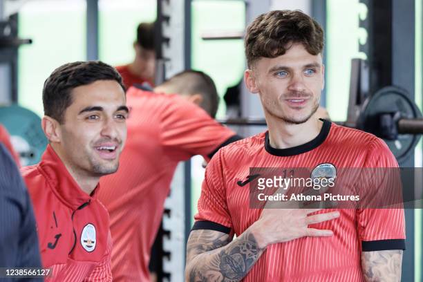 Joel Latibeaudiere and Jamie Paterson of Swansea City speak with team mates during the Swansea City Training Session at The Fairwood Training Ground...