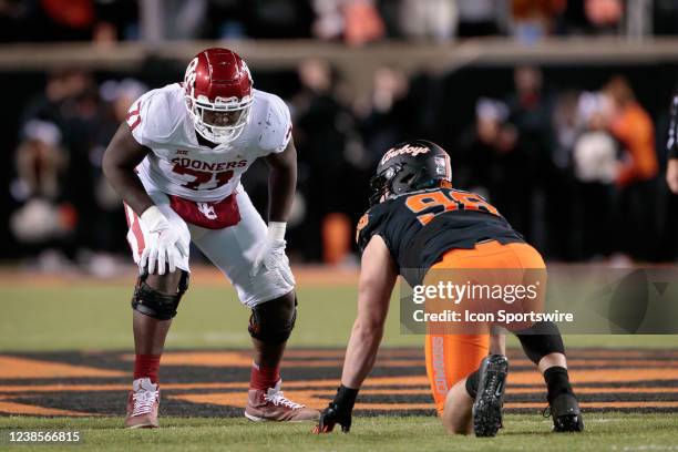 Oklahoma Sooners offensive lineman Anton Harrison lines up against Oklahoma State Cowboys defensive tackle Brendon Evers on November 27th, 2021 at...