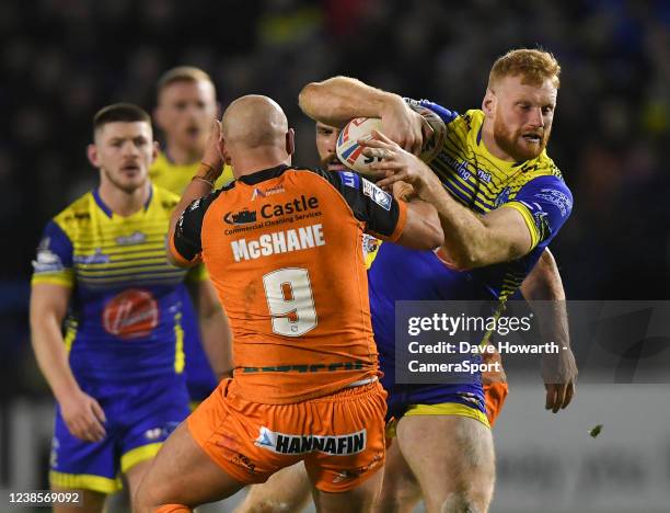 Warrington Wolves' Jack Hughes is tackled by Castleford Tigers' Paul McShane during the Betfred Super League match between Warrington Wolves and...