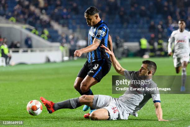 Sokratis Papastathopoulos of Olympiacos battles for the ball with Luis Muriel of Atalanta during the UEFA Europa League Knockout Round Play-Offs Leg...