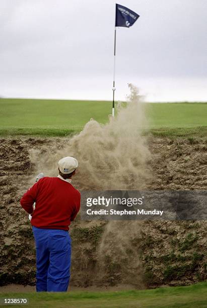 Payne Stewart of the USA plays out of a deep bunker on the 11th hole during the Alfred Dunhill Cup played at The Old Course, St. Andrews, Scotland. \...