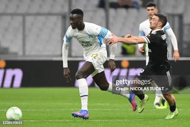 Marseille's French midfielder Pape Gueye fights for the ball with Qarabag's Azerbaijan midfielder Gara Garayev during the UEFA Conference Europa...