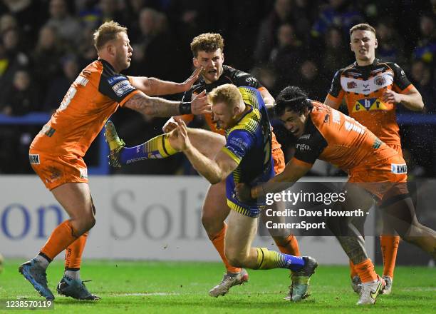 Warrington Wolves' Joe Bullock is tackled during the Betfred Super League match between Warrington Wolves and Castleford Tigers at The Halliwell...