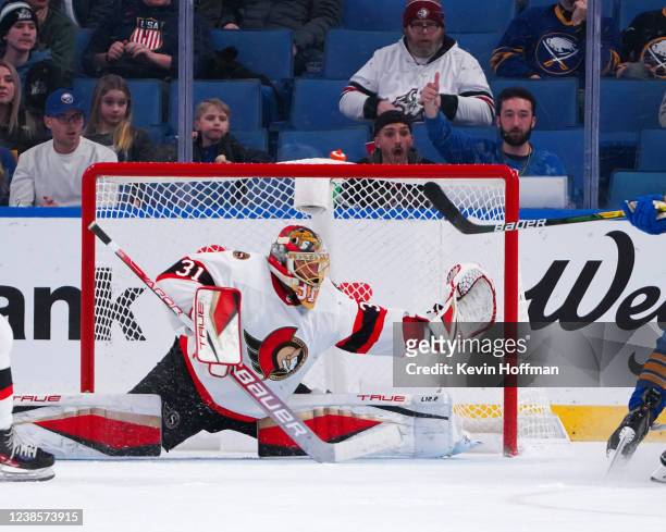 Anton Forsberg of the Ottawa Senators makes the save against Kyle Okposo of the Buffalo Sabres during the second period at KeyBank Center on February...