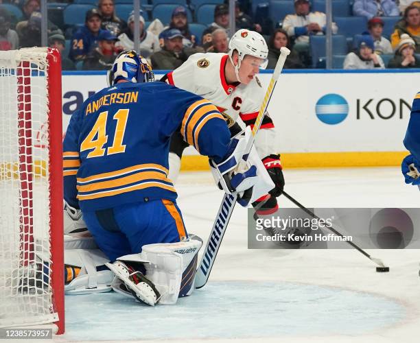 Craig Anderson of the Buffalo Sabres makes the save against Brady Tkachuk of the Ottawa Senators during the second period at KeyBank Center on...