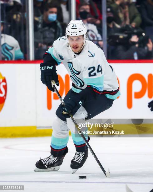 Jamie Oleksiak of the Seattle Kraken plays the puck down the ice during first period action against the Winnipeg Jets at the Canada Life Centre on...