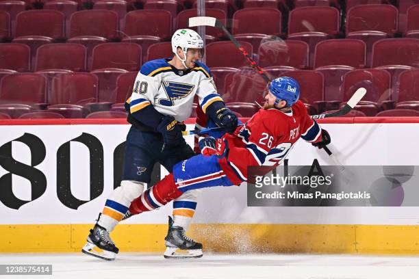 Brayden Schenn of the St. Louis Blues delivers a hit to Jeff Petry of the Montreal Canadiens during the third period at Centre Bell on February 17,...