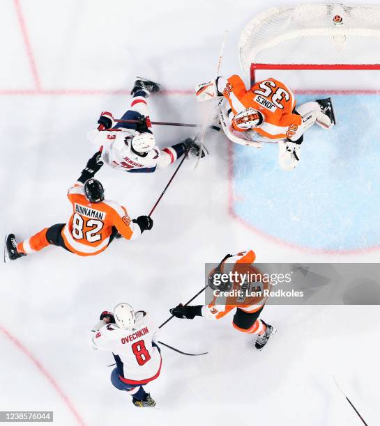 Goaltender Martin Jones of the Philadelphia Flyers protects his net as Connor Bunnaman and Keith Yandle defend against Nick Jensen and Alex Ovechkin...