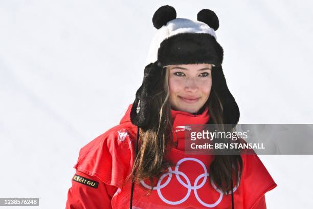 China's Gu Ailing Eileen poses on the podium during the venue ceremony after the freestyle skiing women's freeski halfpipe final run during the...
