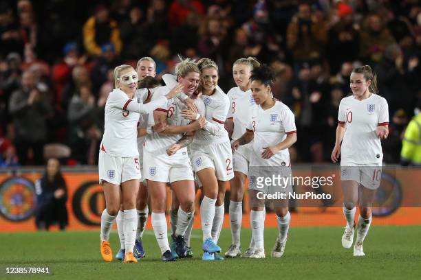 England's Millie Bright celebrates with her team mates after scoring their first goal during the Arnold Clark Cup match between England Women and...