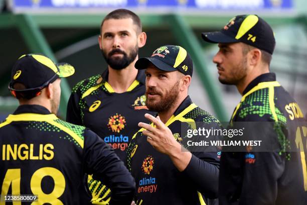 Australia's captain Aaron Finch speaks with teammates before the fourth T20 international cricket match between Australia and Sri Lanka at the...