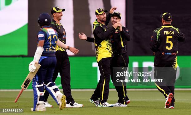 Australia's Glenn Maxwell celebrates with teammate Josh Inglis after running out Sri Lanka batsman Kusal Mendis during the fourth T20 international...