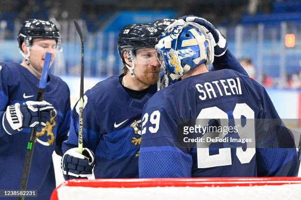 Markus Granlund of Finland and goalkeeper Harri Sateri of Finland celebrate after winning at the men's ice hockey playoff semifinal match between...