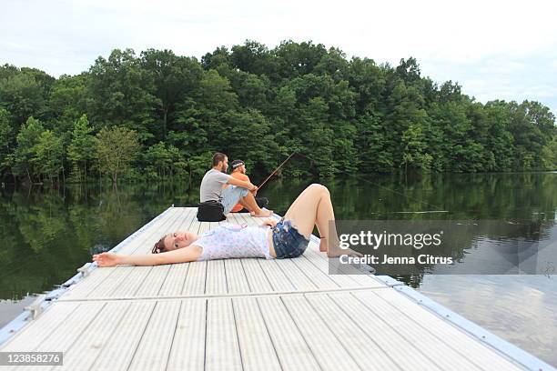 fishing on dock - fishers indiana stock pictures, royalty-free photos & images