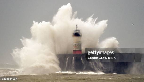 Waves crash over Newhaven Lighthouse and the harbour wall in Newhaven, southern England on February 18 as Storm Eunice brings high winds across the...