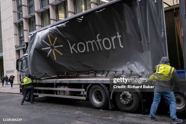 Delivery workers fight to secure side curtain on their lorry, as Storm Eunice sweeps across southern England and Wales and gale force winds sweep...