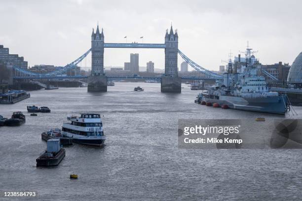 As storm Eunice batters the South East of England with gale force winds and especially strong gusts of wind, a view along the Thames towards Tower...