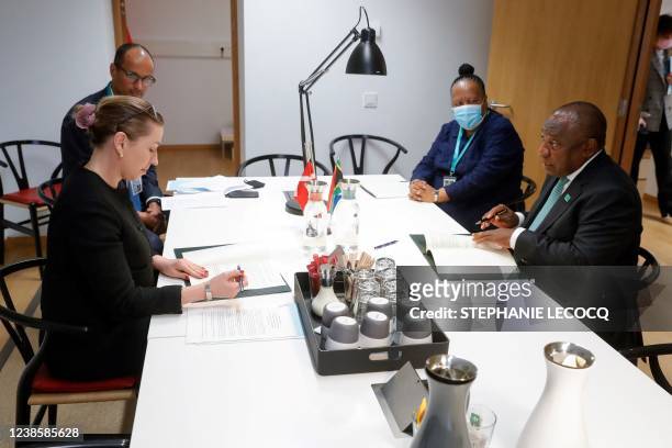 Danish Prime Minister Mette Frederiksen and South Africa's President Cyril Ramaphosa tchat ahead of a meeting on the second day of a European Union...