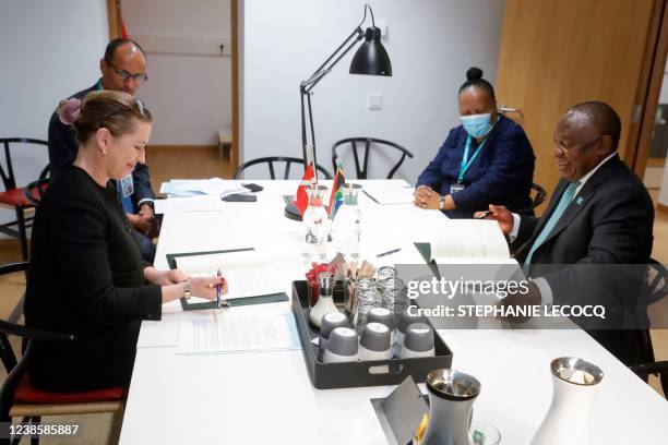 Danish Prime Minister Mette Frederiksen and South Africa's President Cyril Ramaphosa tchat ahead of a meeting on the second day of a European Union...