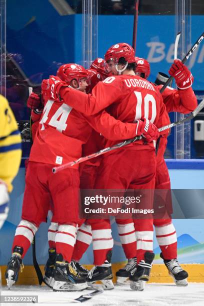 Anton Slepyshev of Russia celebrates after scoring his team's first goal with teammates at the men's ice hockey playoff semifinal match between ROC...