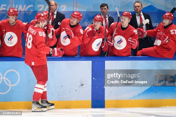 Anton Slepyshev of Russia celebrates after scoring his team's first goal with teammates at the men's ice hockey playoff semifinal match between ROC...