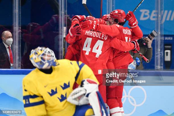 Anton Slepyshev of Russia celebrates after scoring his team's first goal with teammates at the men's ice hockey playoff semifinal match between ROC...