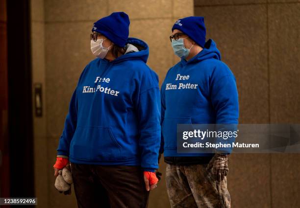 Two people wear hats and shirts that read Free Kim Potter before the sentencing hearing for former Brooklyn Center police officer Kim Potter at the...