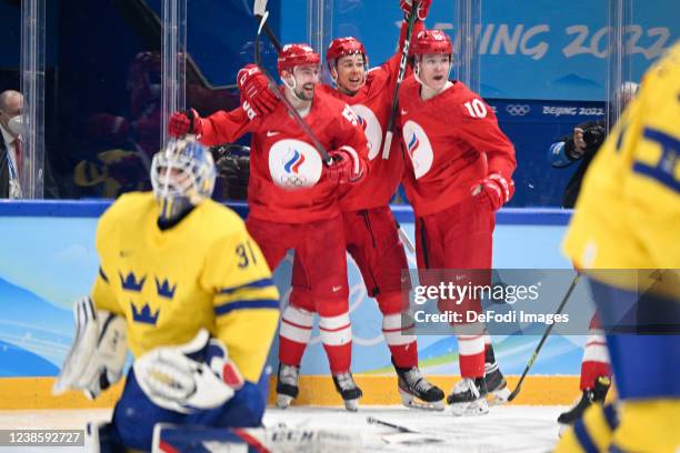 Anton Slepyshev of Russia celebrates after scoring his team's first goal with teammates at the men's ice hockey playoff semifinal match between ROC...